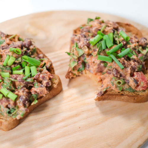 two slices of bread with bean mash salad on top