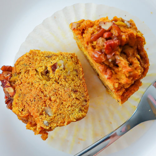 Muffin sliced in half on a plate.