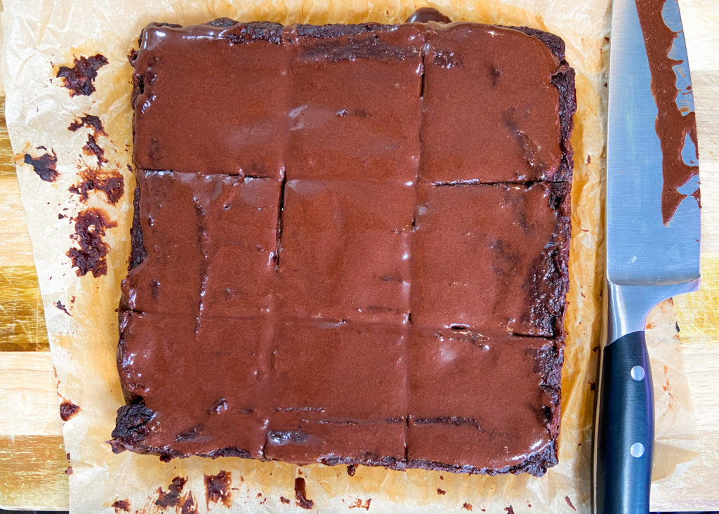 Freshly baked sweet potato brownies cut into squares on a cutting board