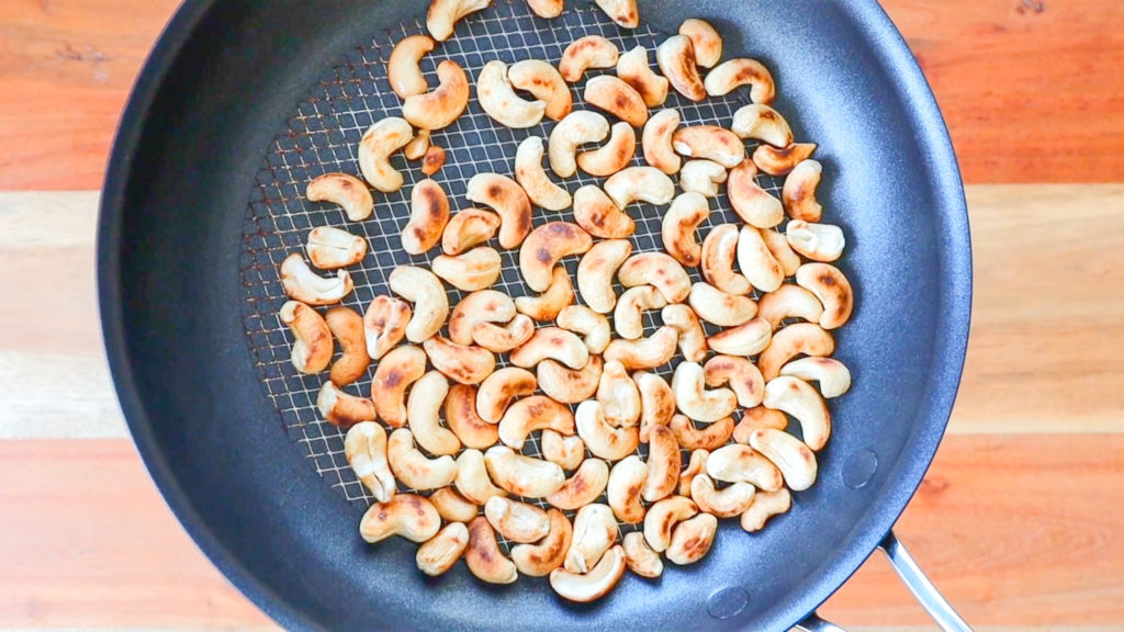 Cashews toasting in a skillet