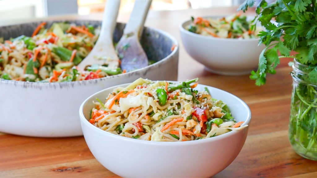 White bowl of crunchy cashew noodle salad