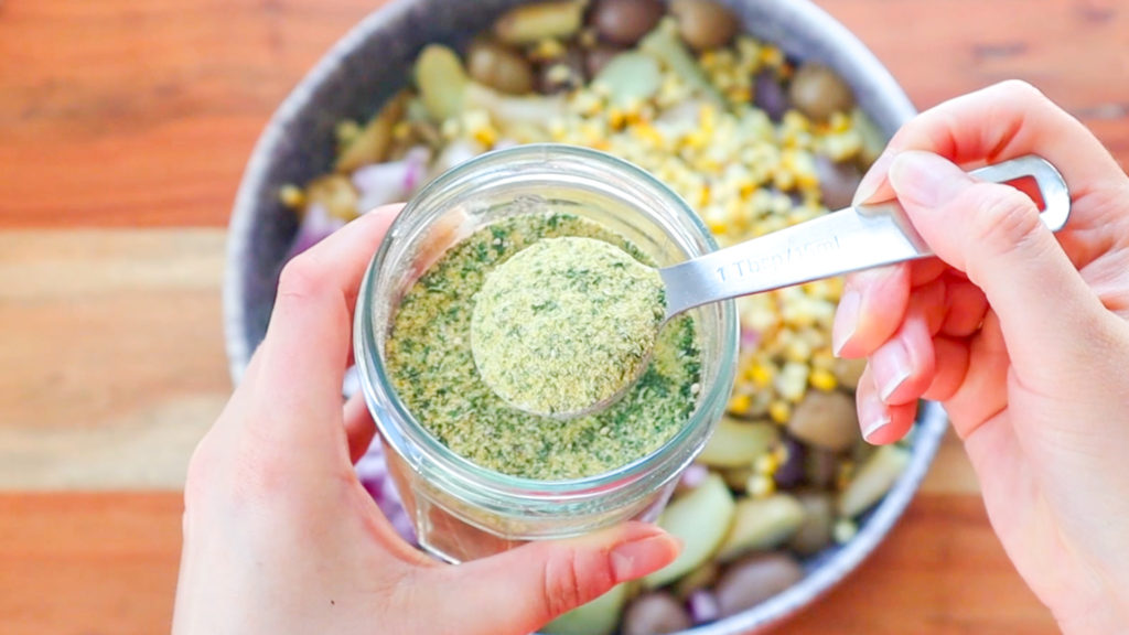 Hand holding a spoonful of homemade Ranch Powder