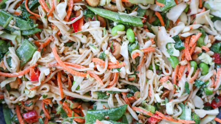 close up image showing various textures and ingredients of crunchy cashew noodle salad