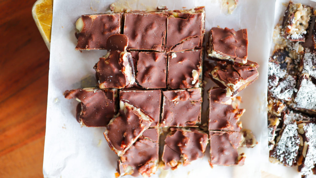 Chocolate date bark (dessert with ayers of dates, nut butter, nuts and chocolate)