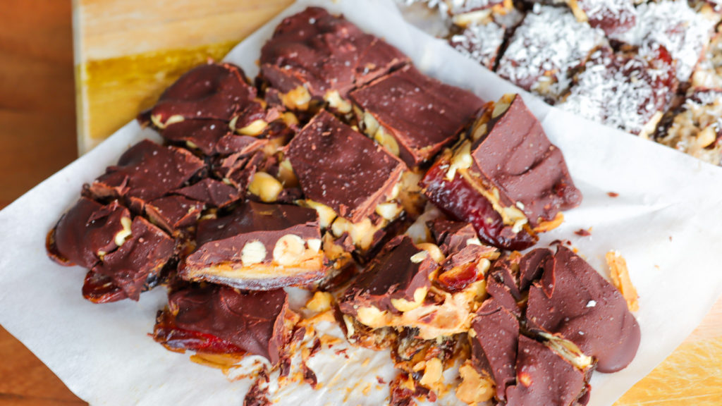 Chocolate date bark (dessert with ayers of dates, nut butter, nuts and chocolate)