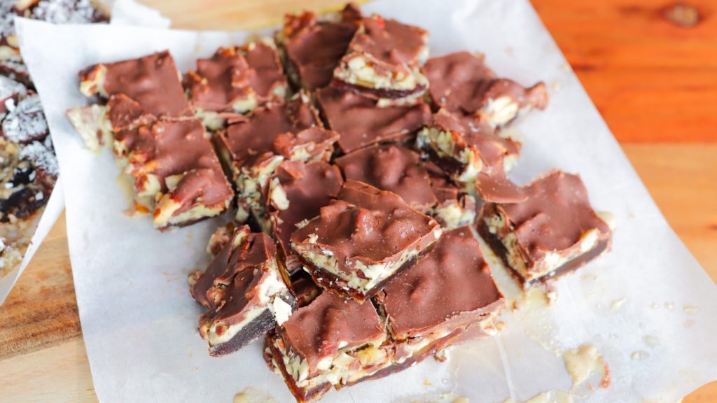 Chocolate date bark (dessert with layers of dates, nut butter, nuts and chocolate)