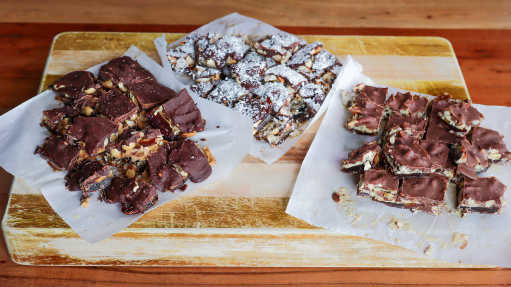 3 groups of chocolate date bark (layers of dates, nut butter, nuts and chocolate)