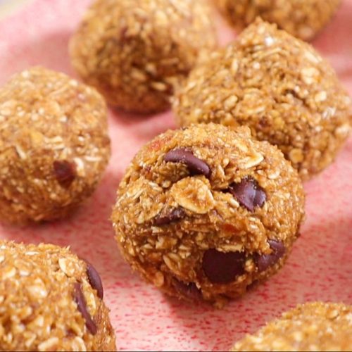 close up photo of pumpkin spice bliss balls, revealing the texture of the oats, spiced and chocolate chips