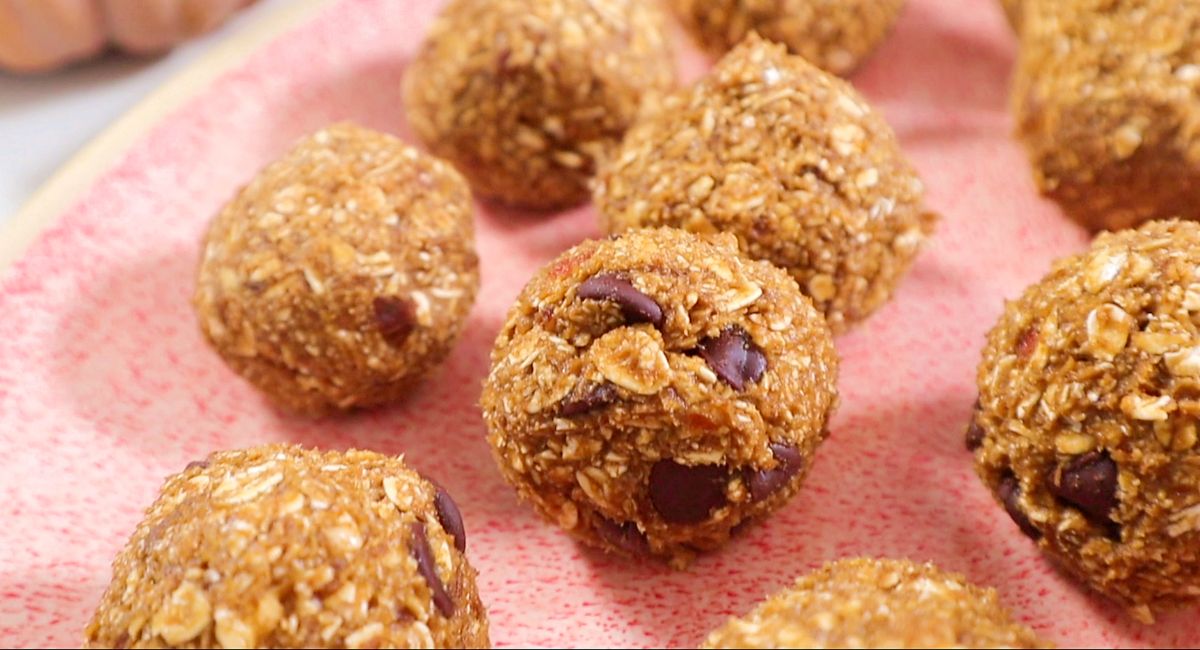 close up photo of pumpkin spice bliss balls, revealing the texture of the oats, spiced and chocolate chips