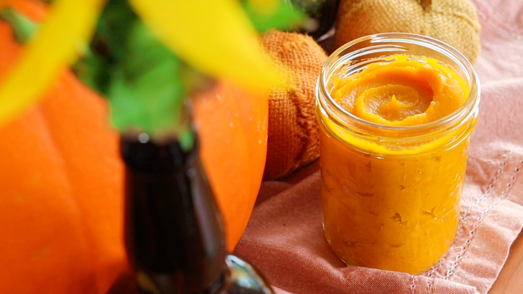 a jar of orange pumpkin puree on a table